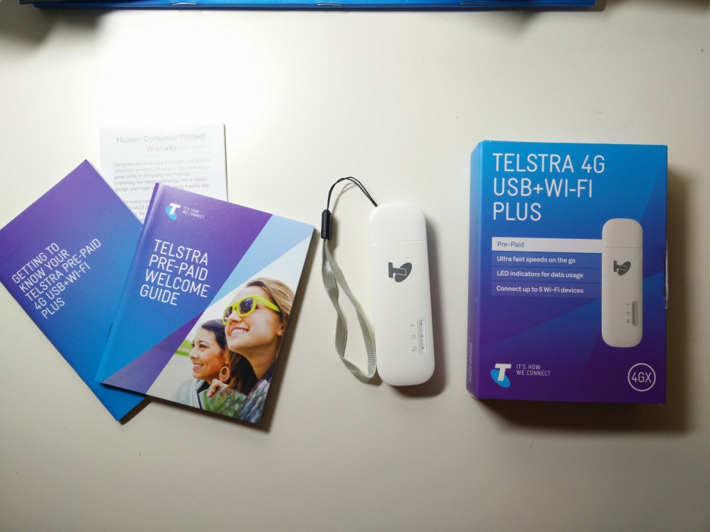 Inside the Telstra 4G USB+Wi-Fi Plus box: the dongle itself along with some documentation